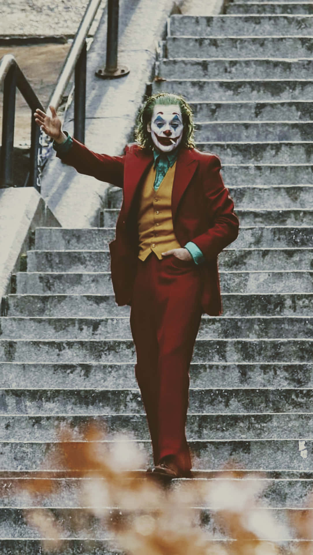 A Joker Walking Down Some Stairs Background