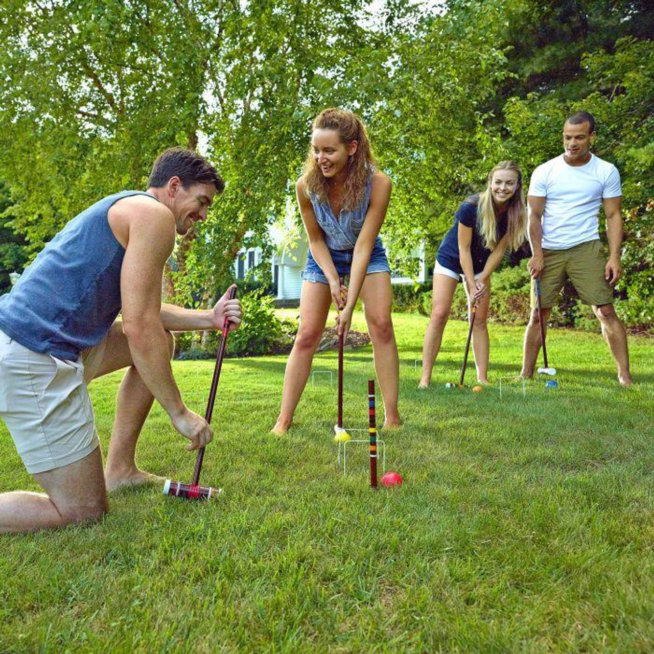 A Joyful Family Playing Croquet Outdoors