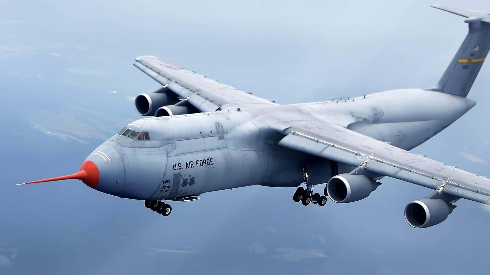 A Jumbo Jet Soars Across Open Skies Background