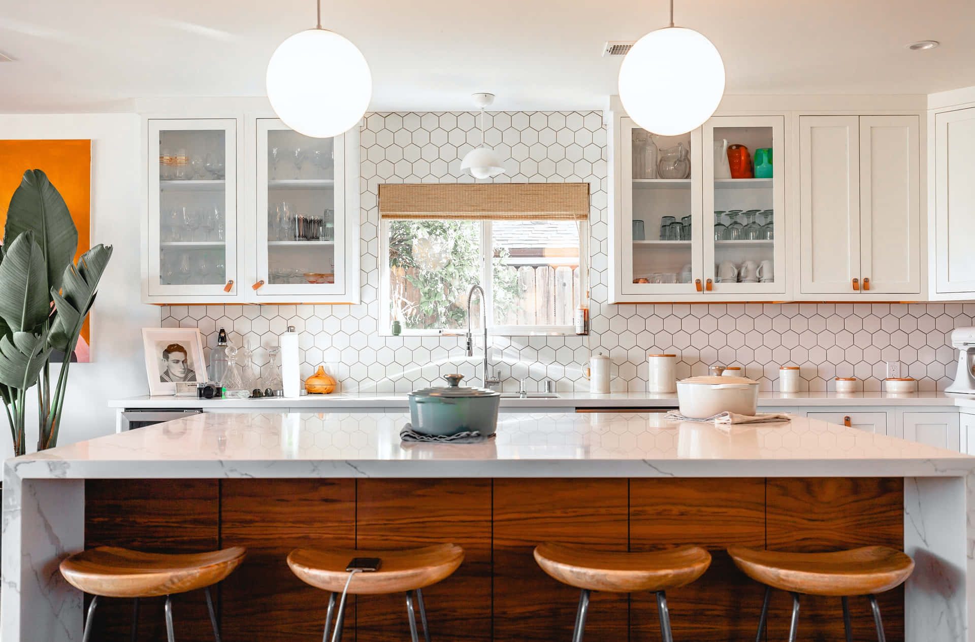 A Kitchen With A Large Island And Stools Background