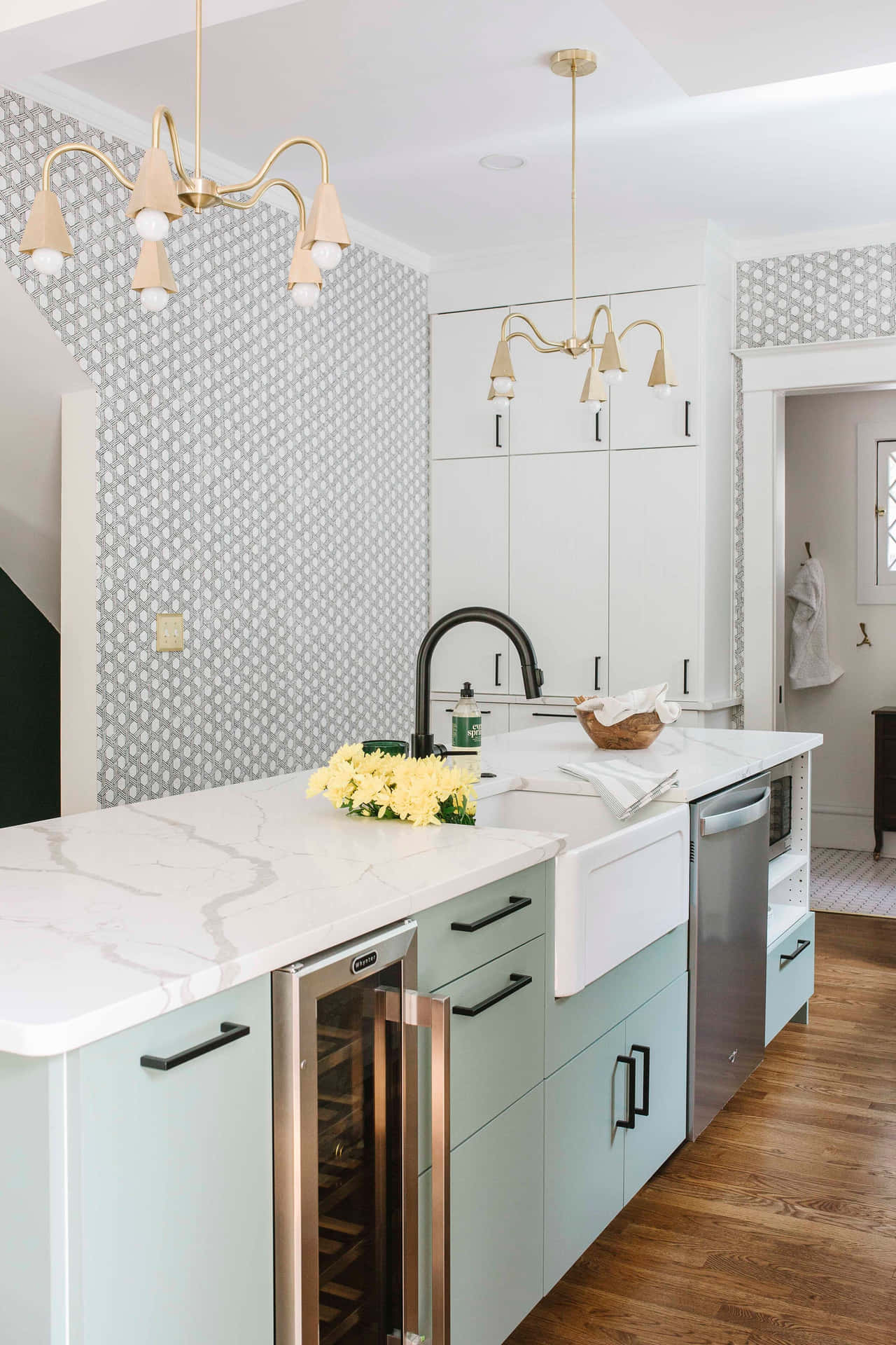 A Kitchen With A White Island And A White Sink Background