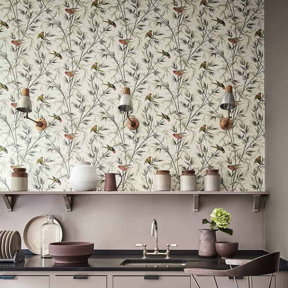 A Kitchen With A White Sink And A Wallpaper Background