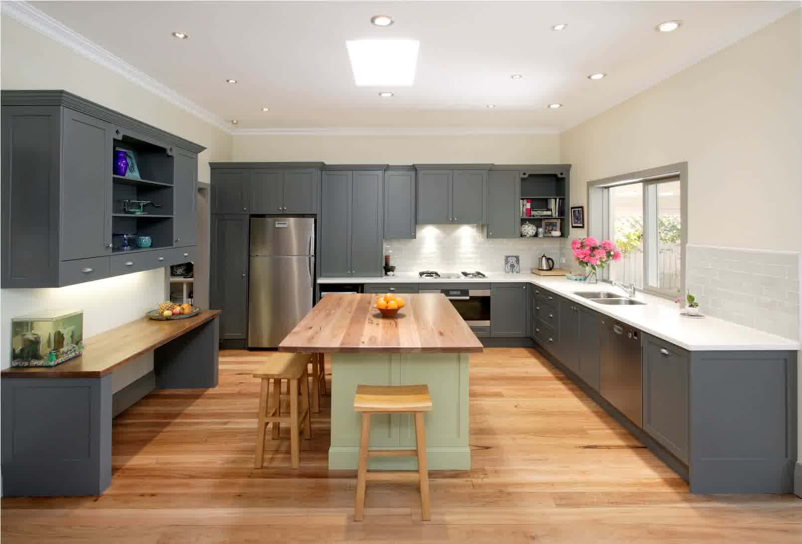 A Kitchen With Grey Cabinets And Wooden Floors Background