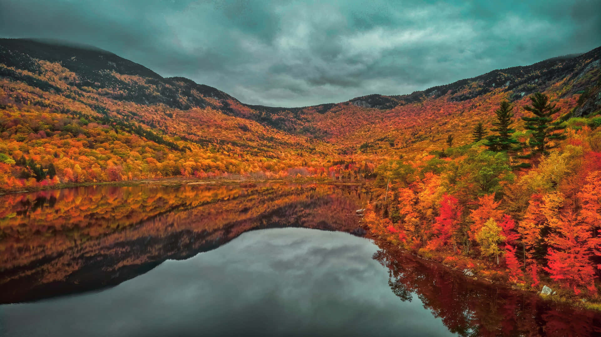 A Lake Surrounded By Colorful Autumn Trees Background