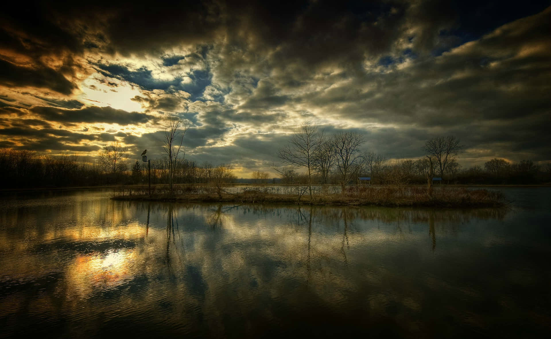 A Lake With Clouds And Trees In The Background Background