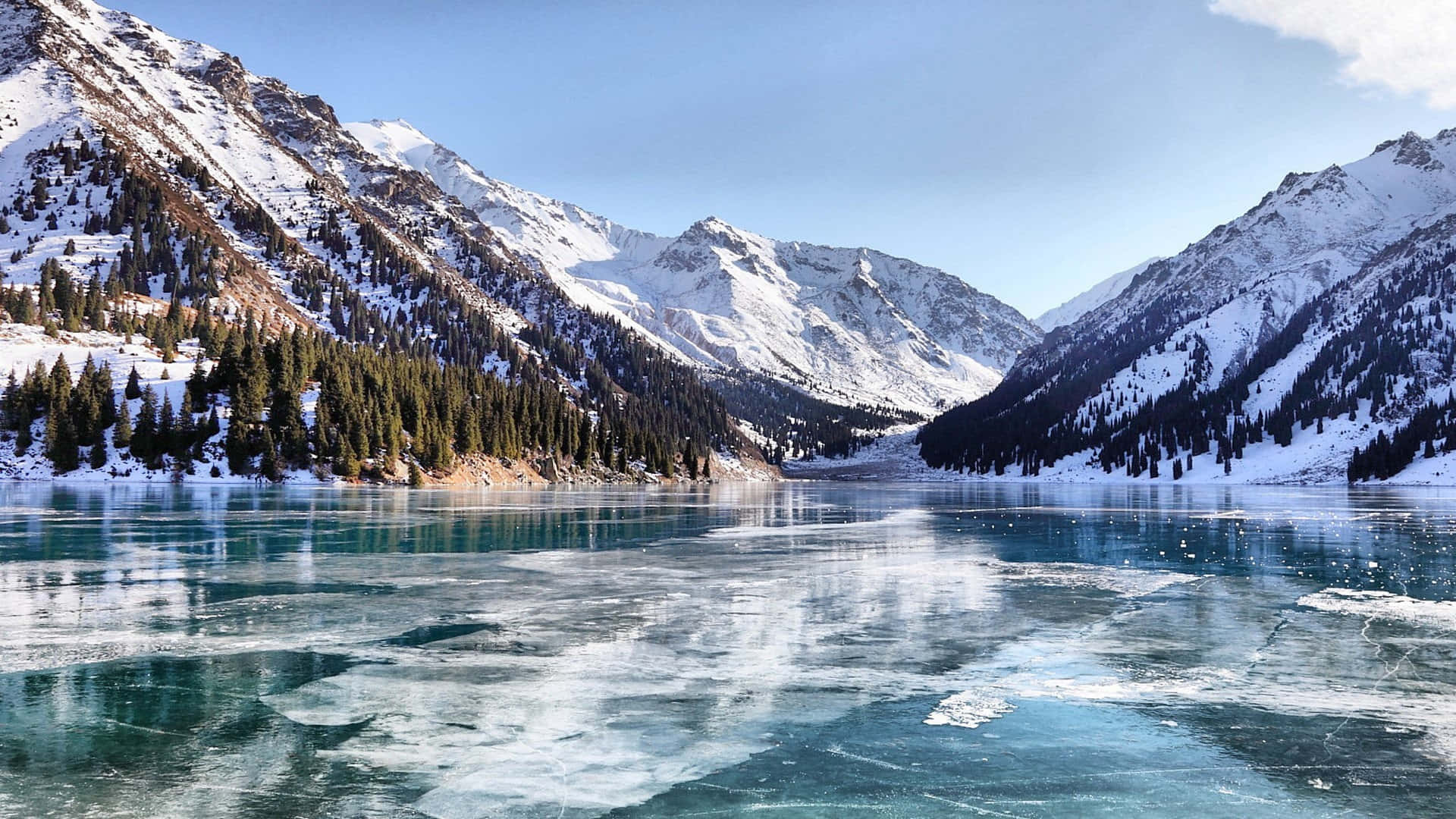 A Lake With Ice Floating In It Near Mountains Background