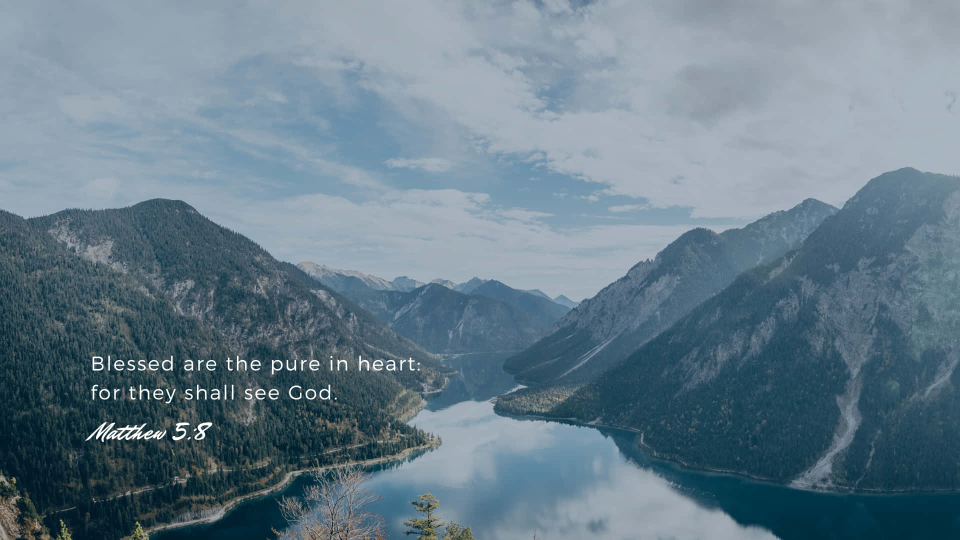 A Lake With Mountains And A Quote Background