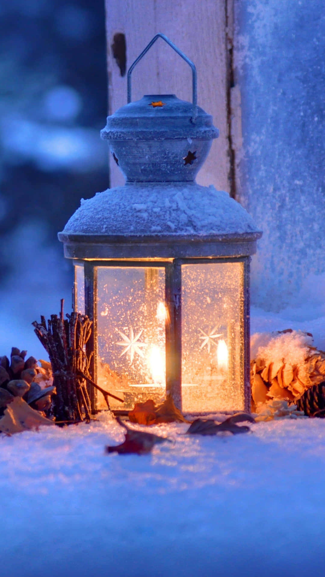 A Lantern Is Lit Up In The Snow Background