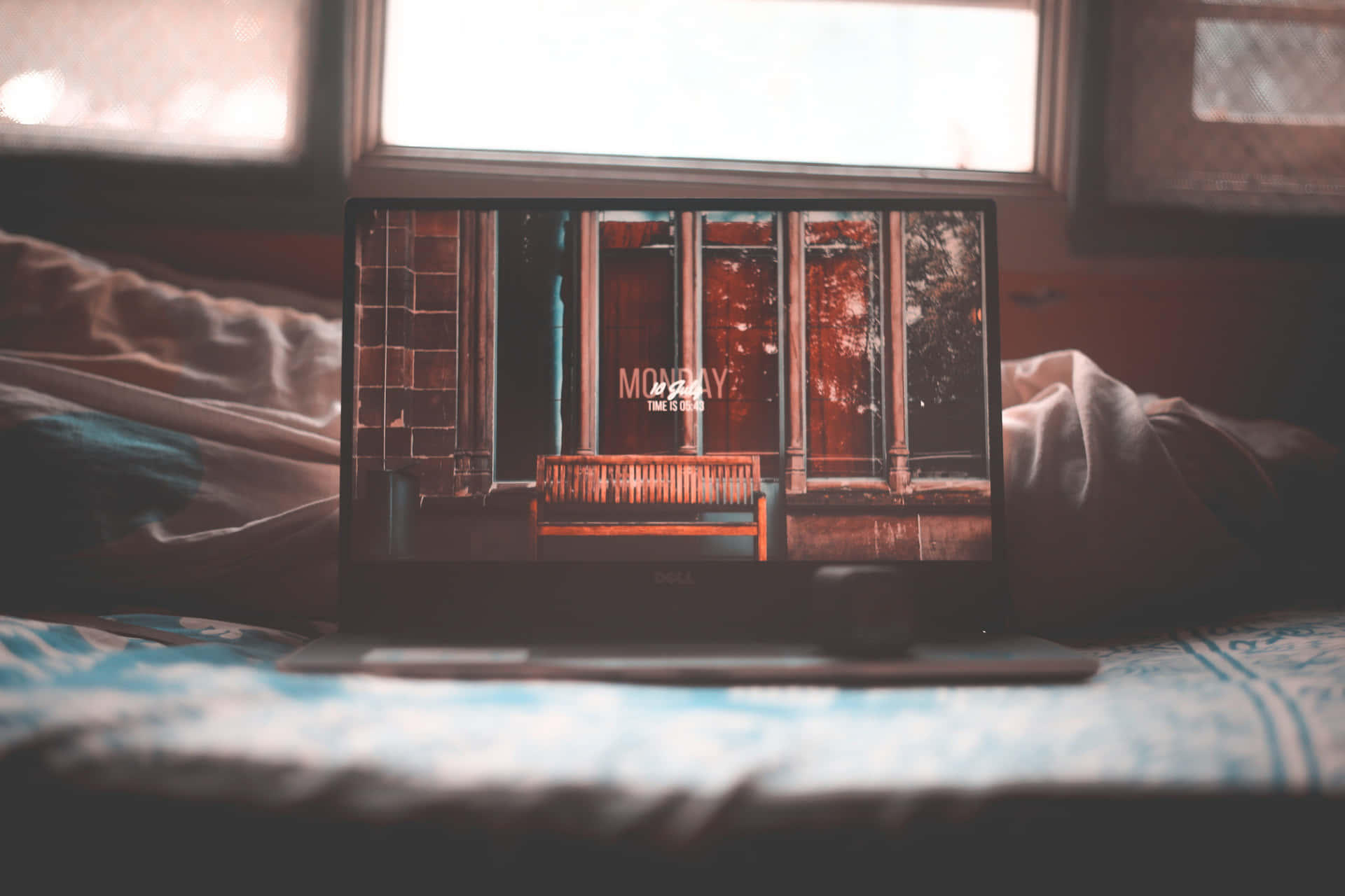 A Laptop On A Bed