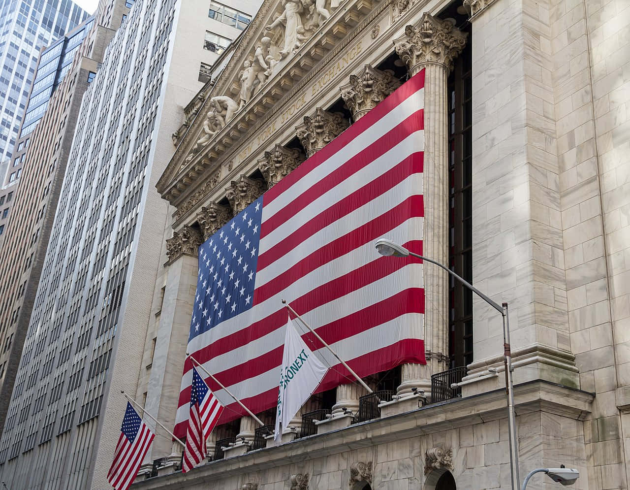 A Large American Flag Is On The Wall Of The New York Stock Exchange