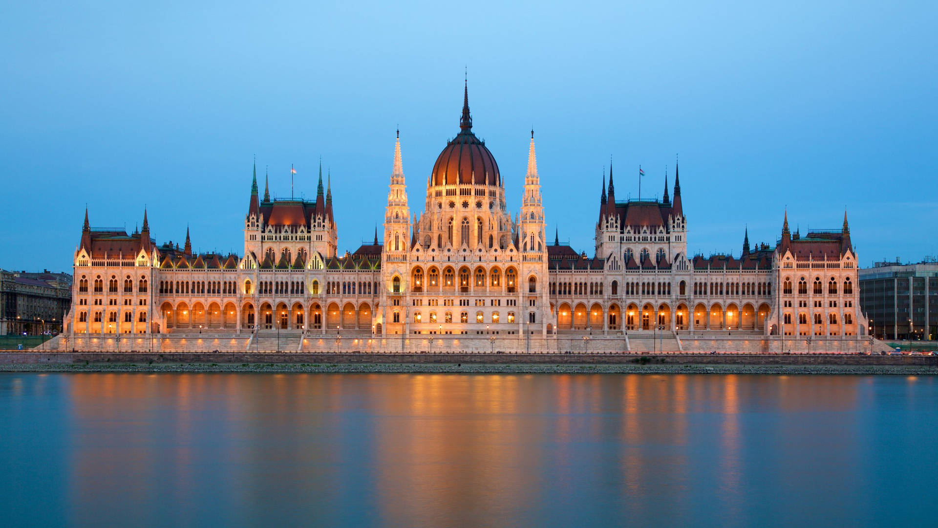 A Large Building Is Lit Up At Night Background