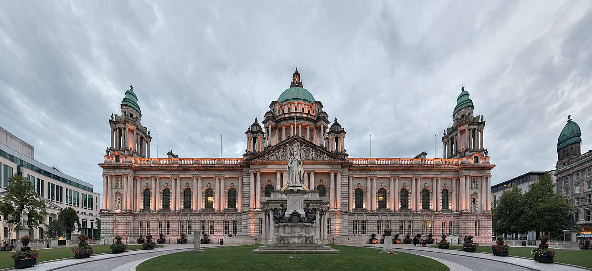 A Large Building With A Clock Tower In The Middle Background