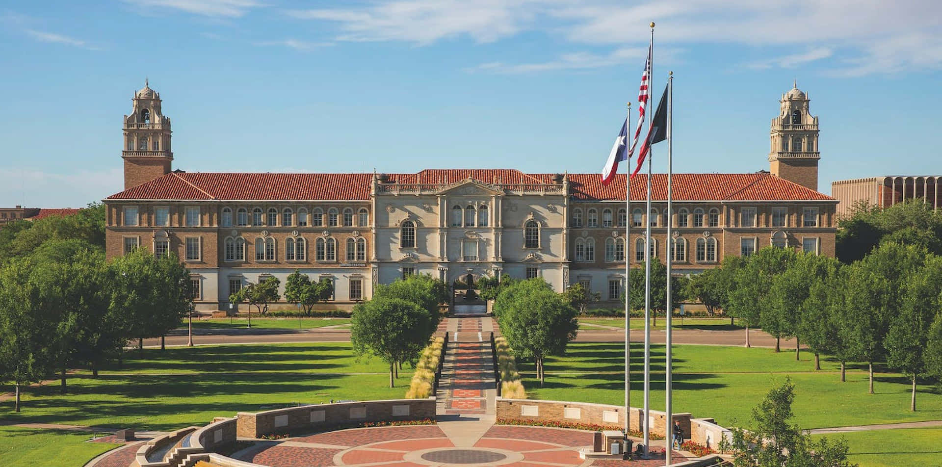 A Large Building With A Flag Flying In Front Of It Background