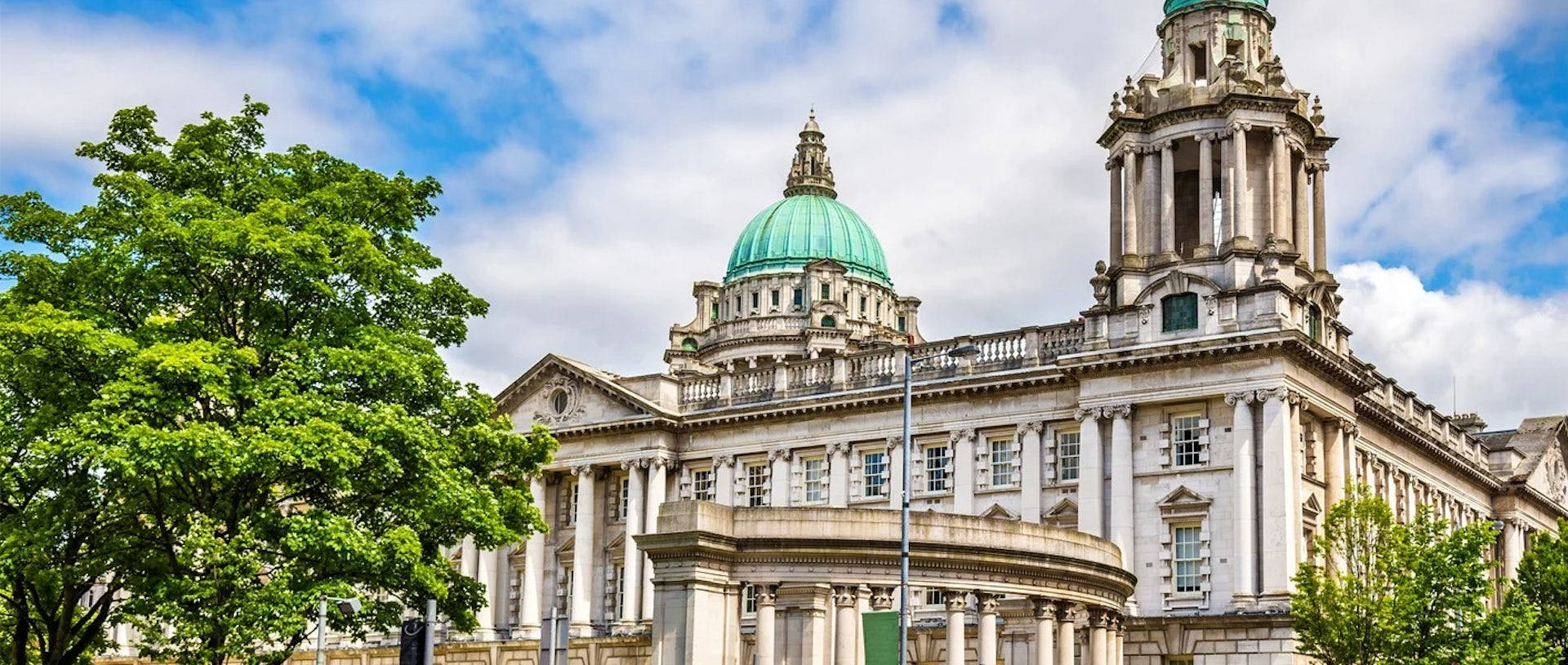 A Large Building With A Green Dome On Top