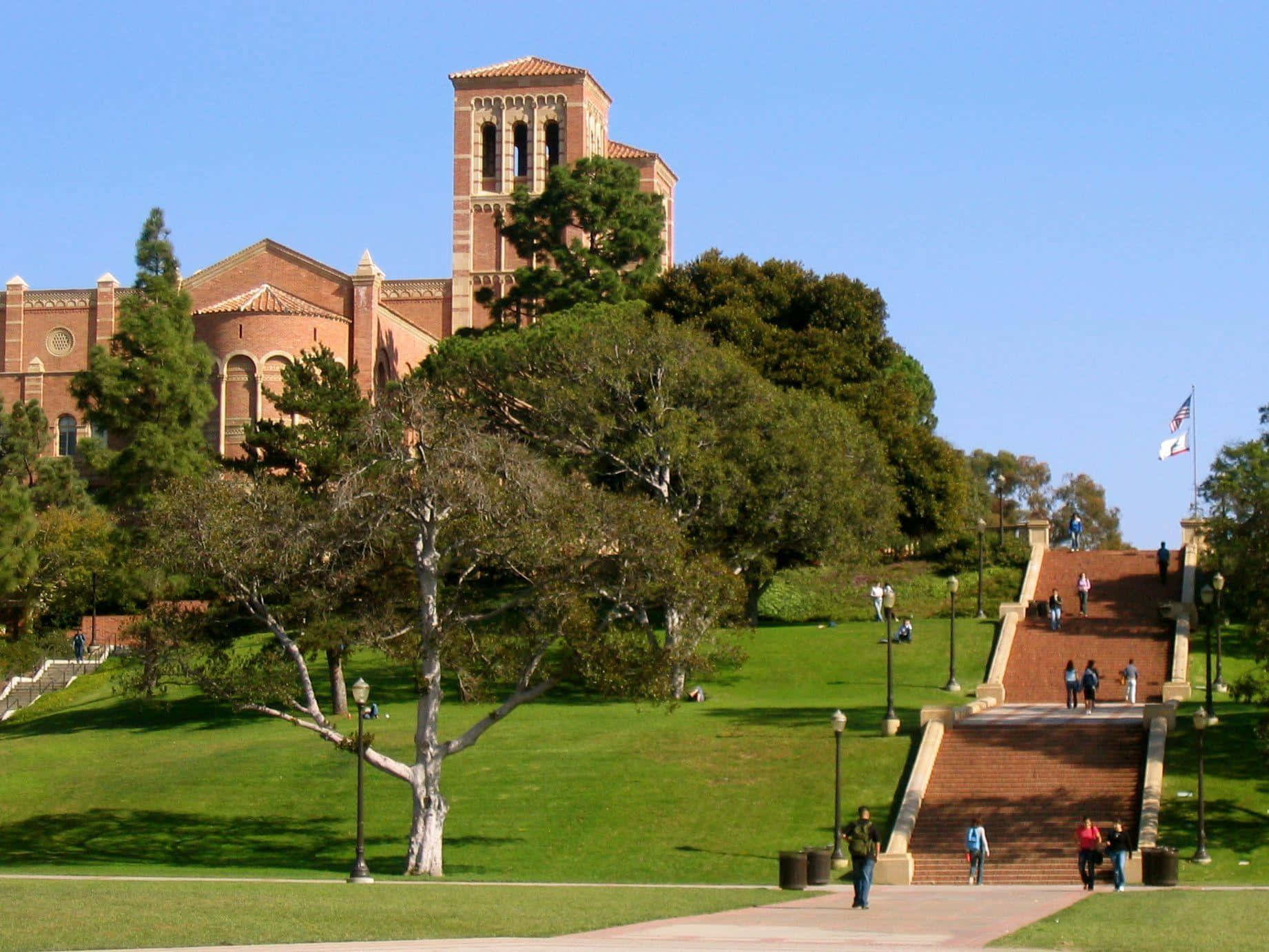 A Large Building With A Large Green Lawn Background