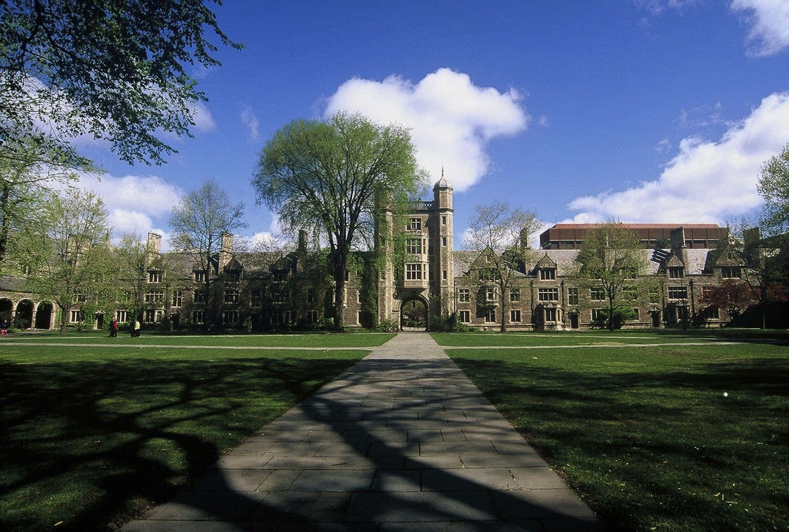 A Large Building With Trees And Grass In The Background Background