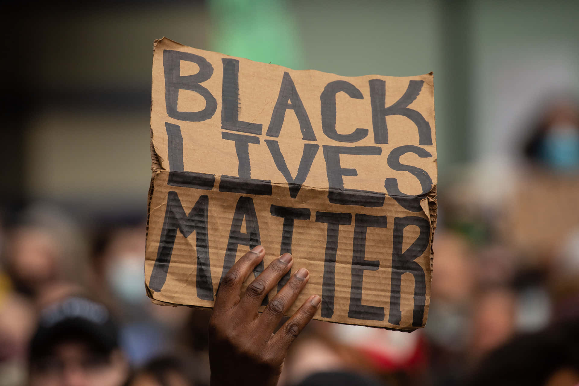 A Large Crowd Protesting Against Systemic Racism And Inequality Background