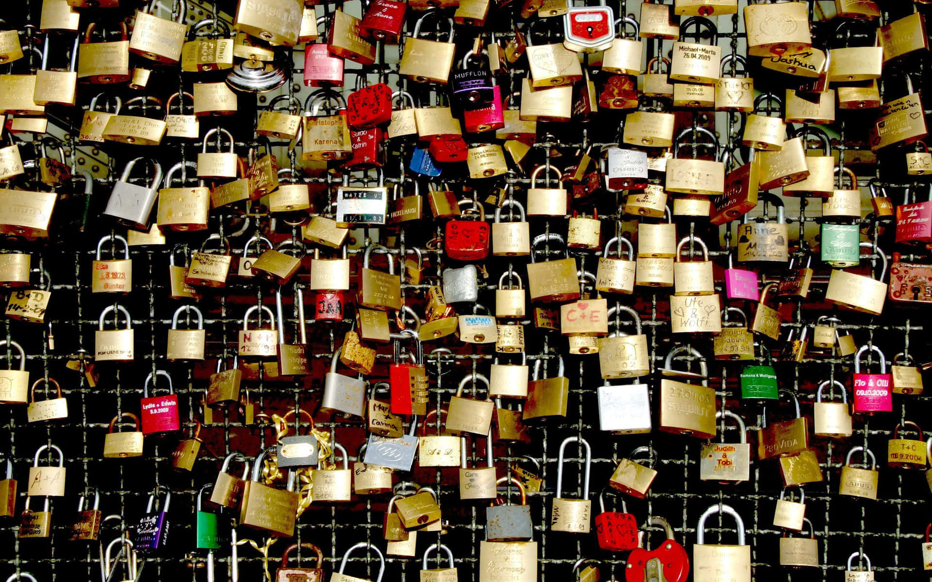 A Large Number Of Padlocks Are Attached To A Wall Background