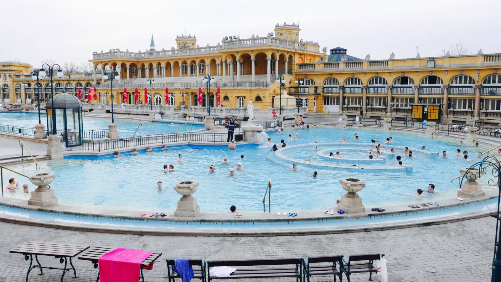 A Large Pool With People In It Background