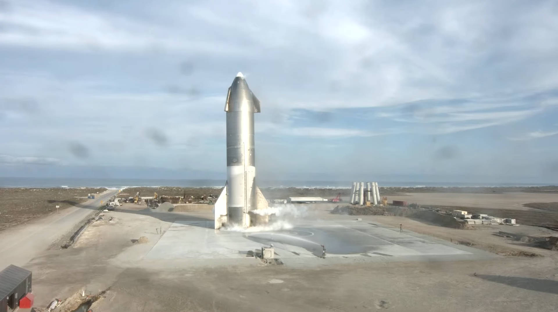 A Large Rocket Is Being Launched From A Field Background