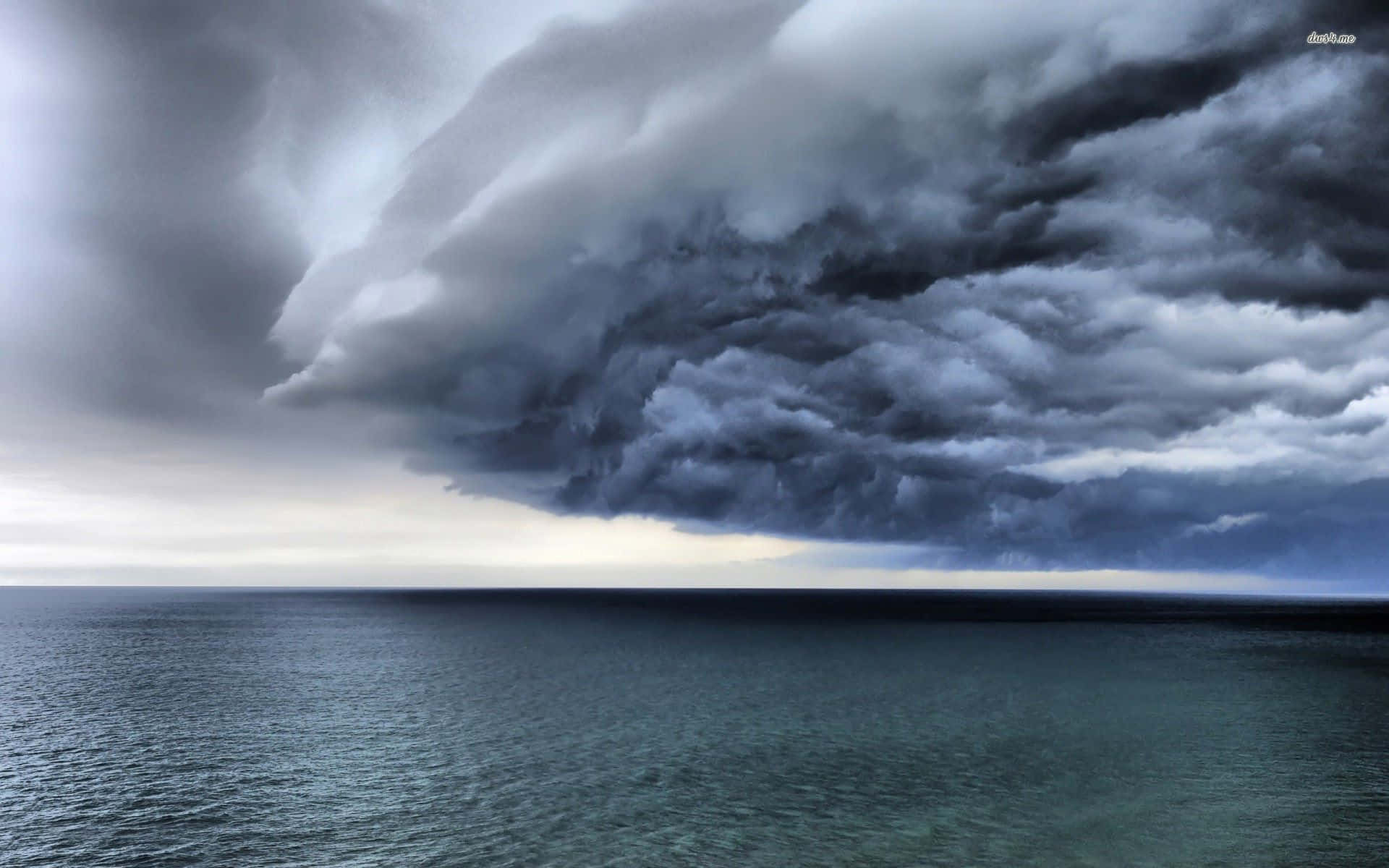 A Large Storm Cloud Is Seen Over The Ocean Background