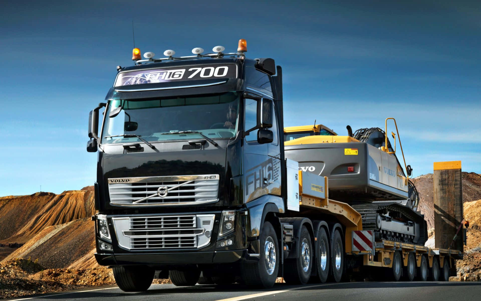 A Large Truck Is Driving Down The Road Background