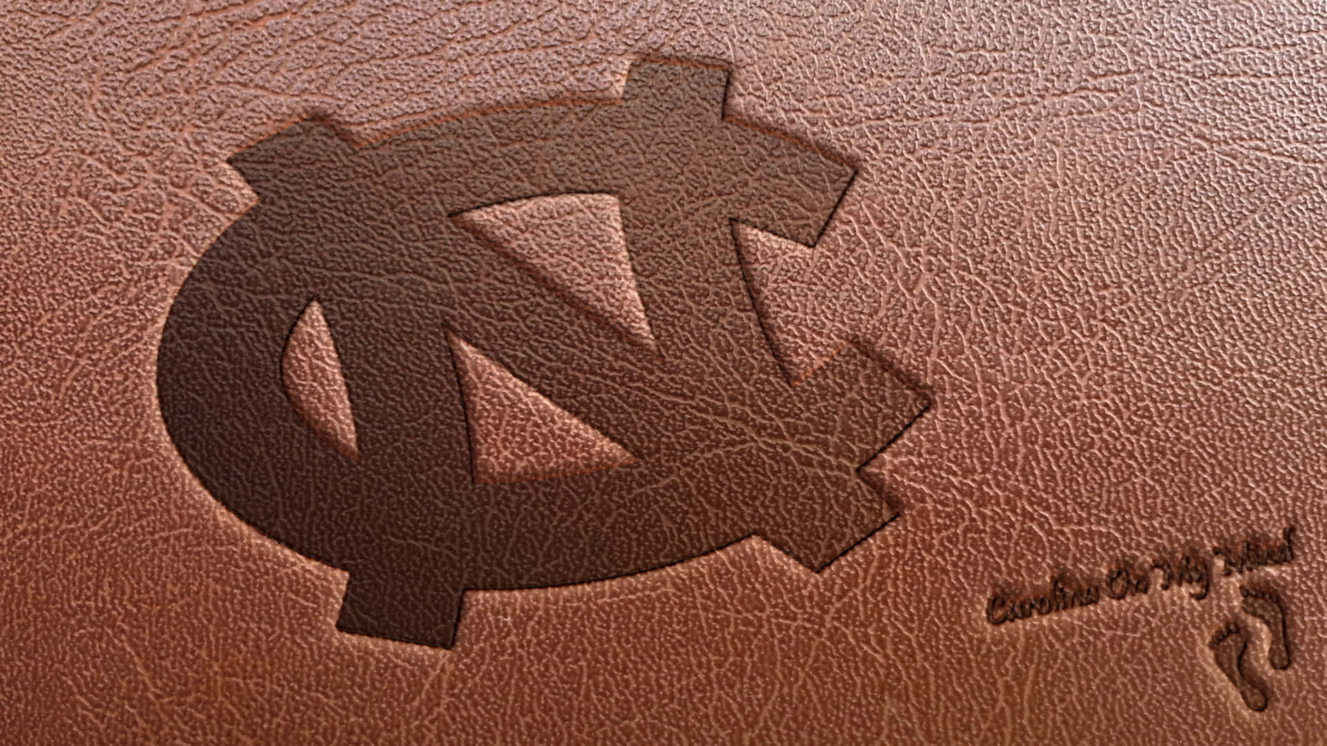 A Leather Notebook With The North Carolina Logo On It