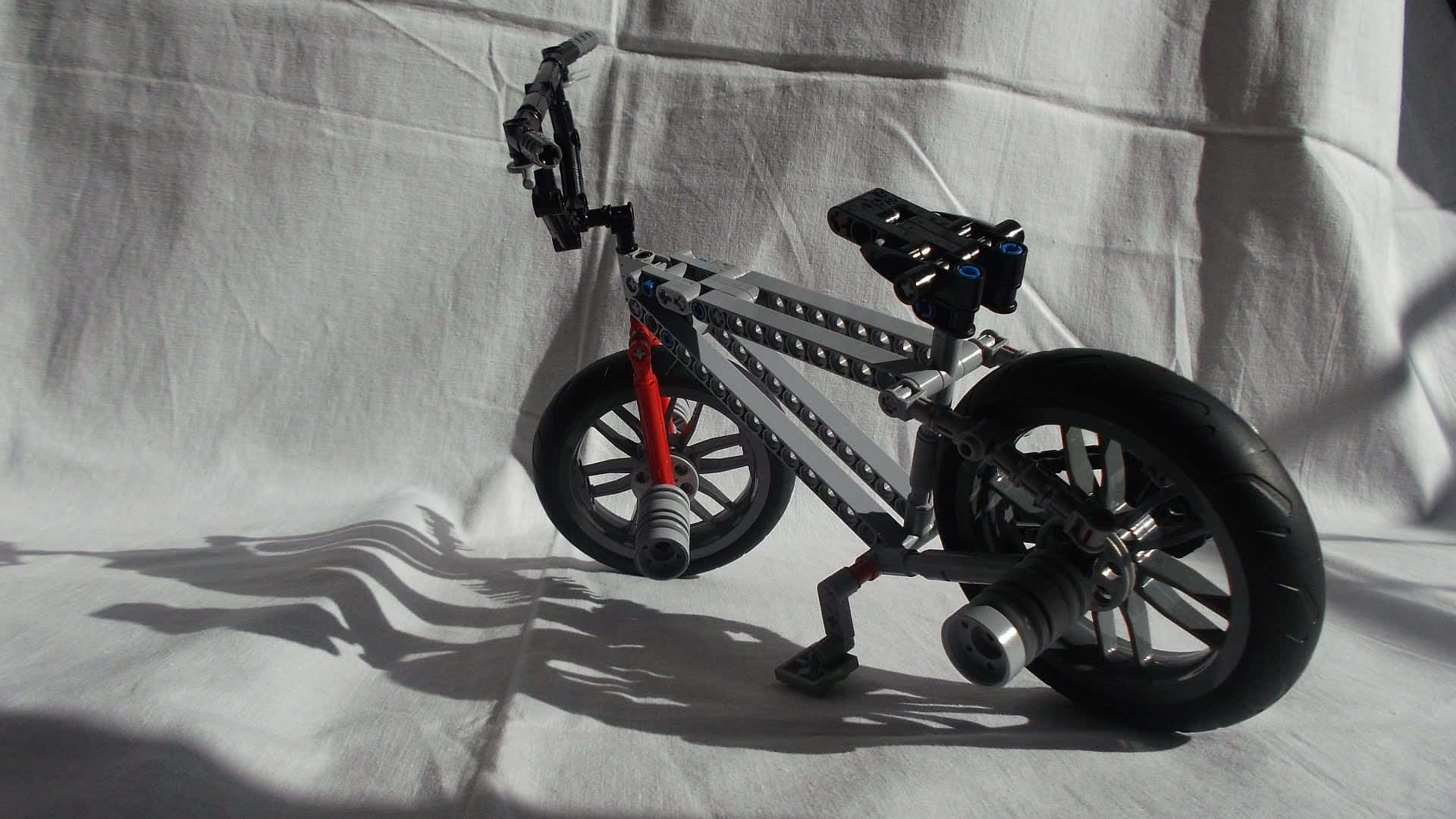 A Lego Bike On A White Cloth Background