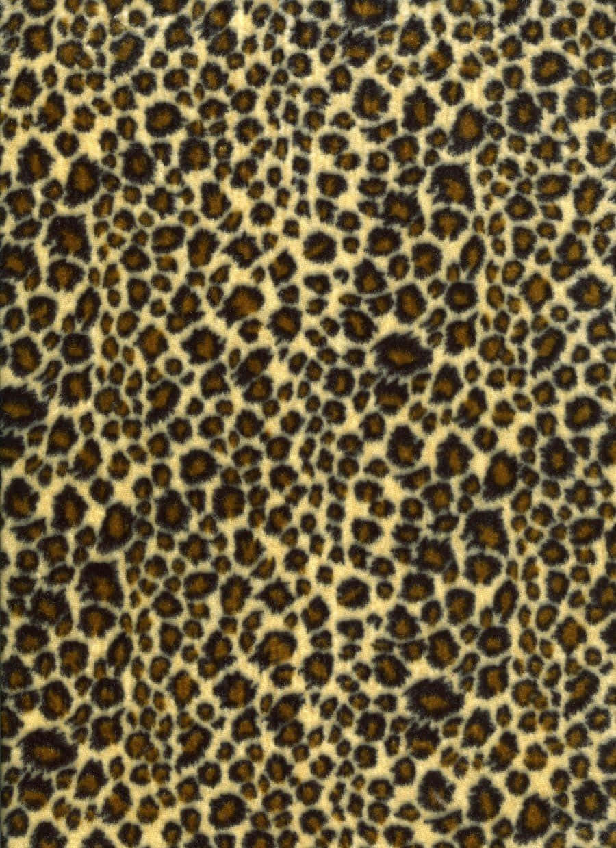 A Leopard Print Fabric With Black Spots Background