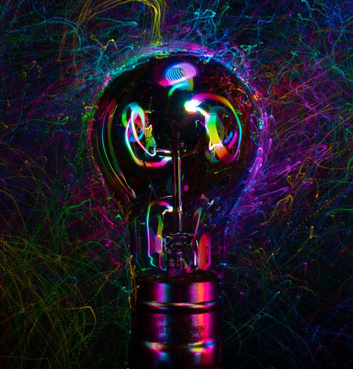 A Light Bulb Illuminating With Colorful Gears And Cogs Inside