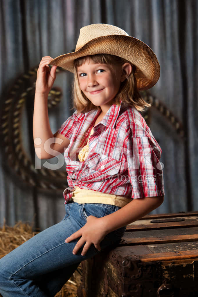 A Little Girl Wearing A Cowboy Hat Background