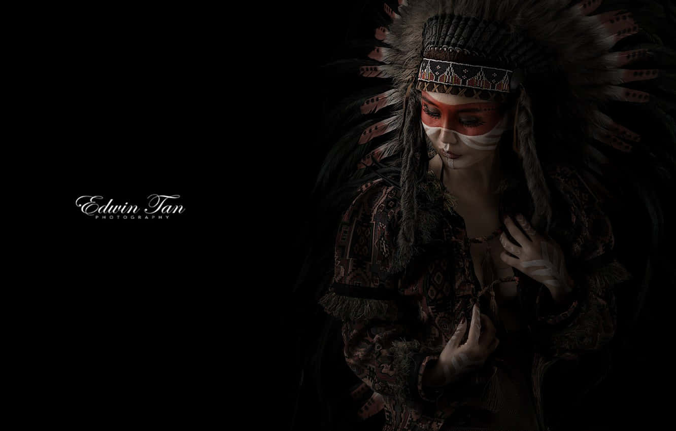 A Lone Blackfeet Native American Man Stands On The Slope Of A Mountain And Looks Out At The Horizon
