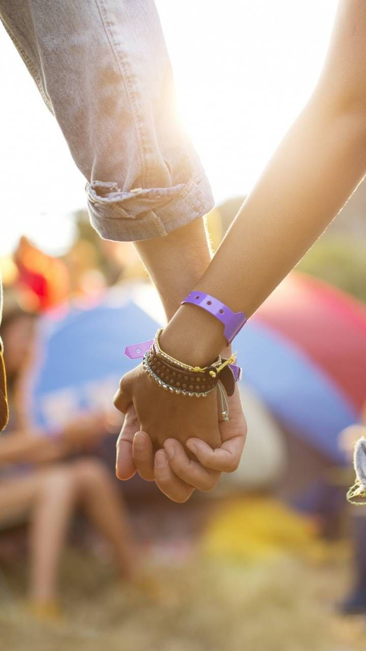 A Loving Connection: Hands Intertwined In Broad Daylight. Background