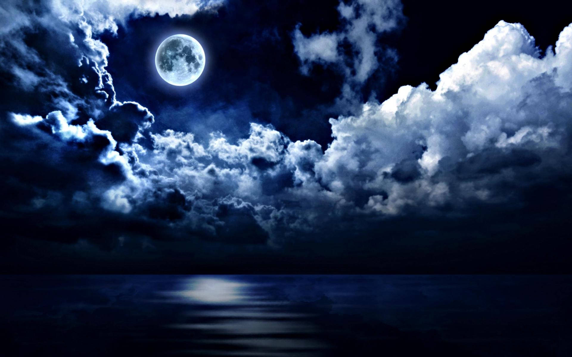 A Magical Blue Hue Is Illuminating The Full Moon Reflecting Off A Calm Night Sea. Background