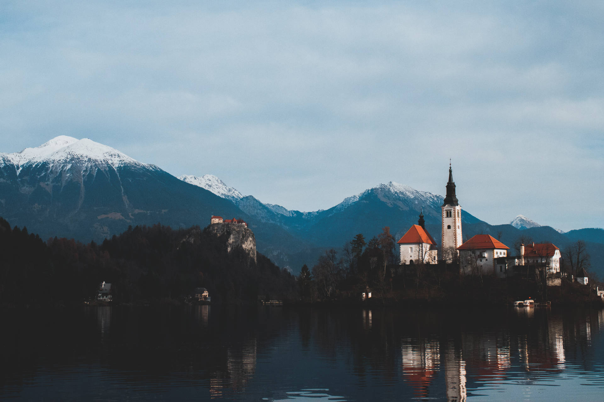 A Majestic Lake With A Castle Tower In Reflection Background