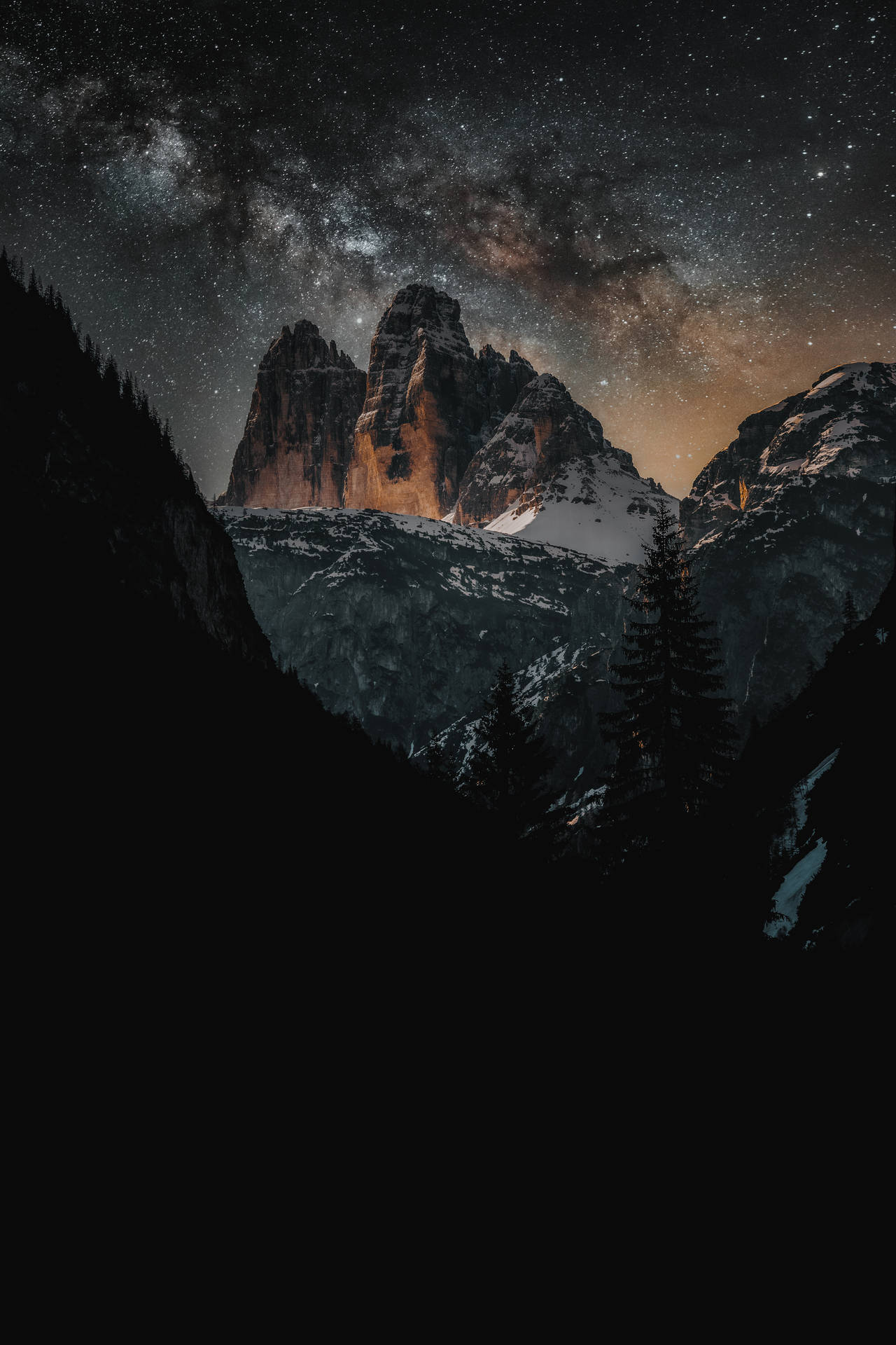 A Majestic View Of The Night Sky Over A Snow-capped Mountain Background