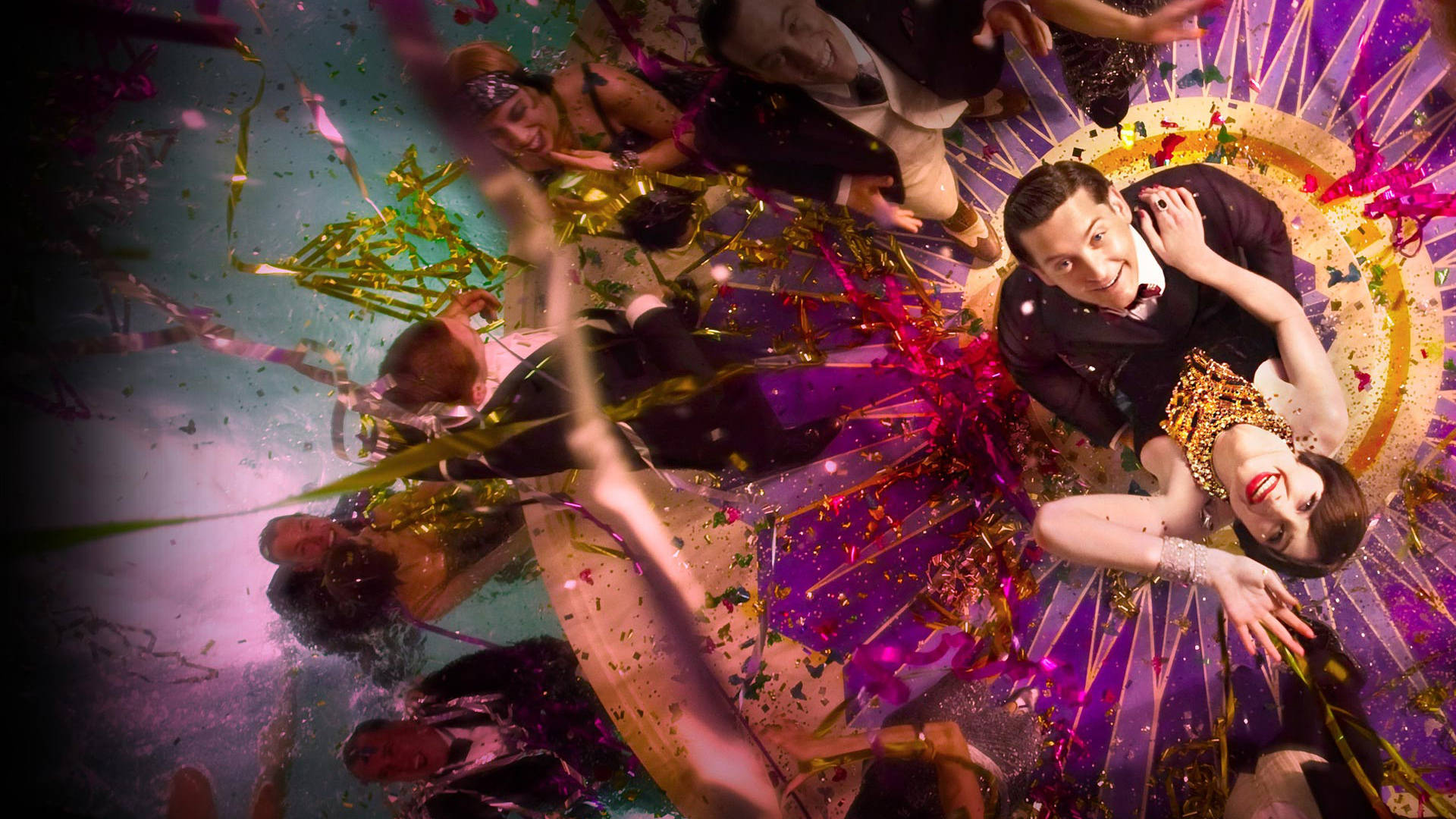 A Man And Woman Are Dancing In A Circle Of Confetti Background