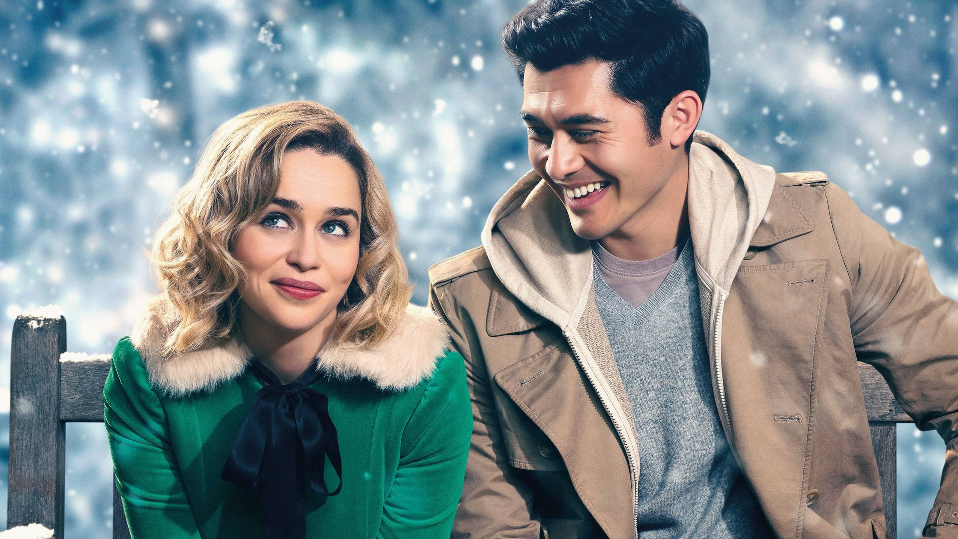 A Man And Woman Sitting On A Bench In The Snow Background