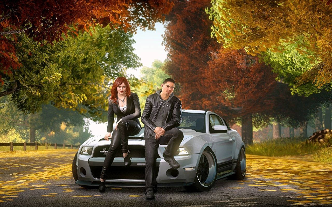 A Man And Woman Sitting On A Car In The Fall Background