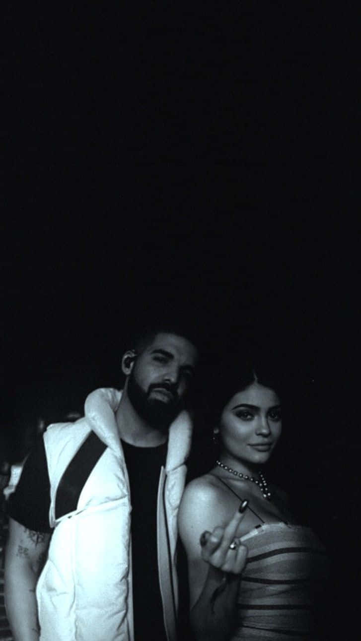 A Man And Woman Standing Next To Each Other Background