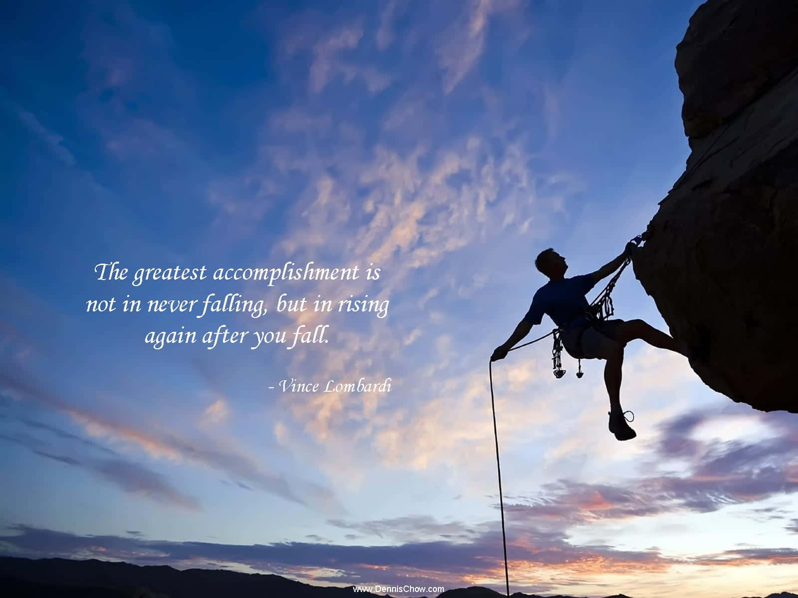 A Man Climbing A Cliff With A Quote Background