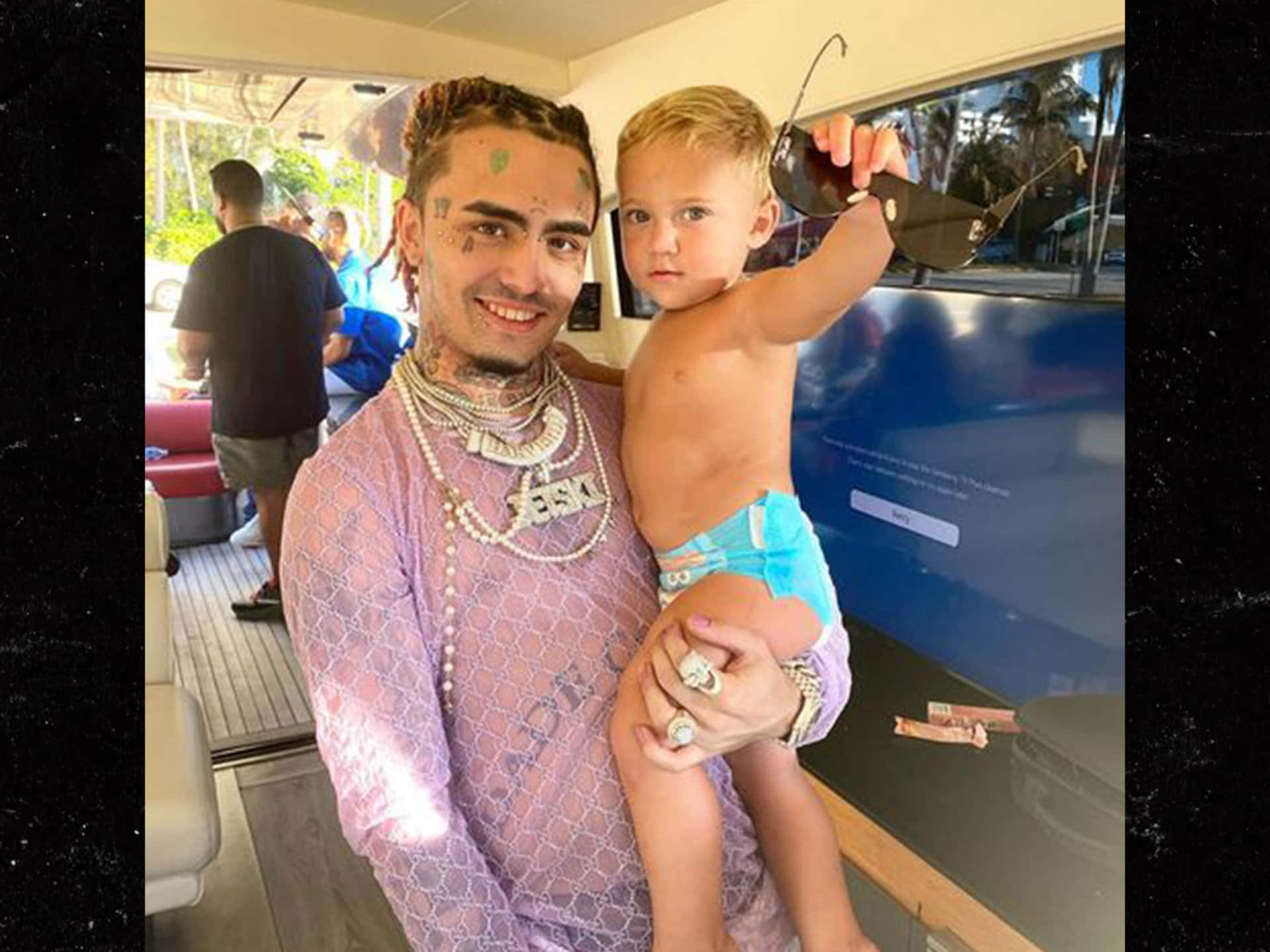 A Man Holding A Child In A Boat Background