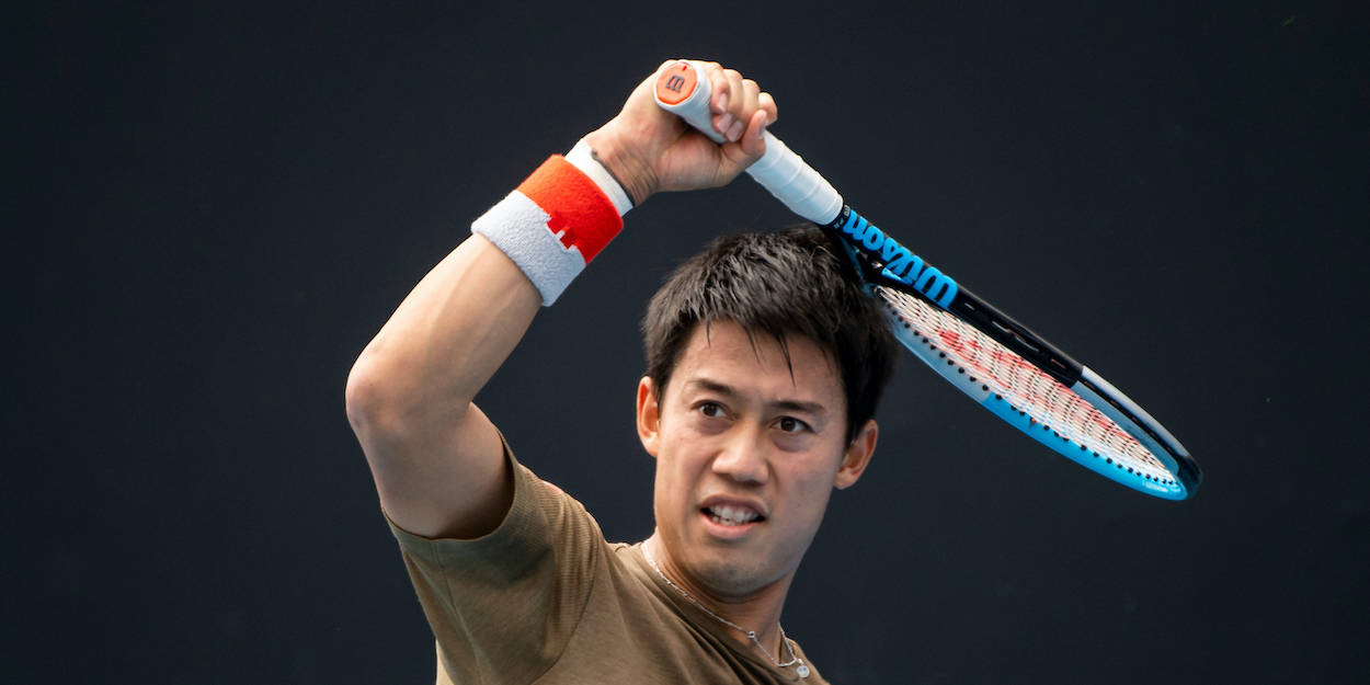 A Man Holding A Tennis Racket