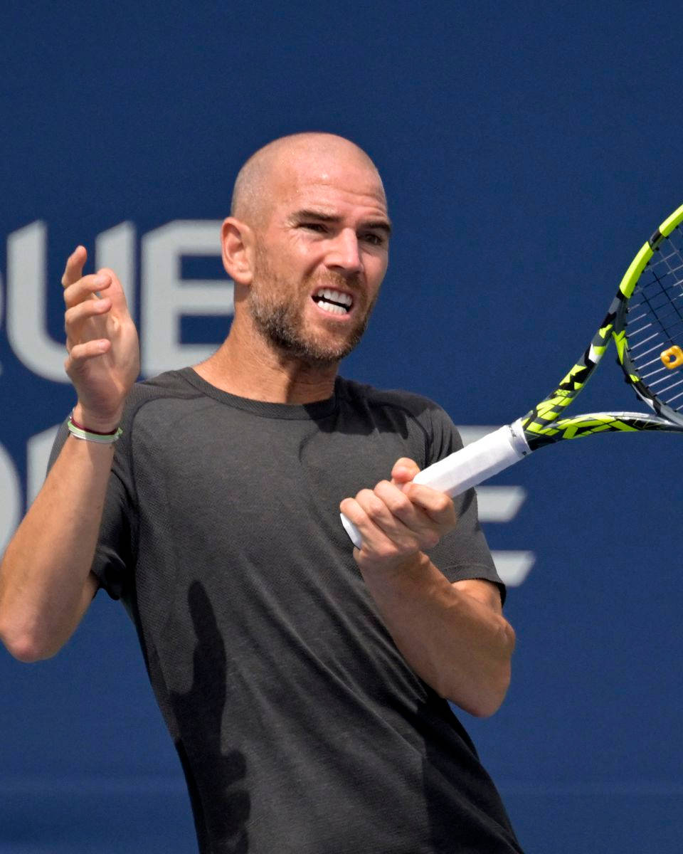 A Man Holding A Tennis Racket