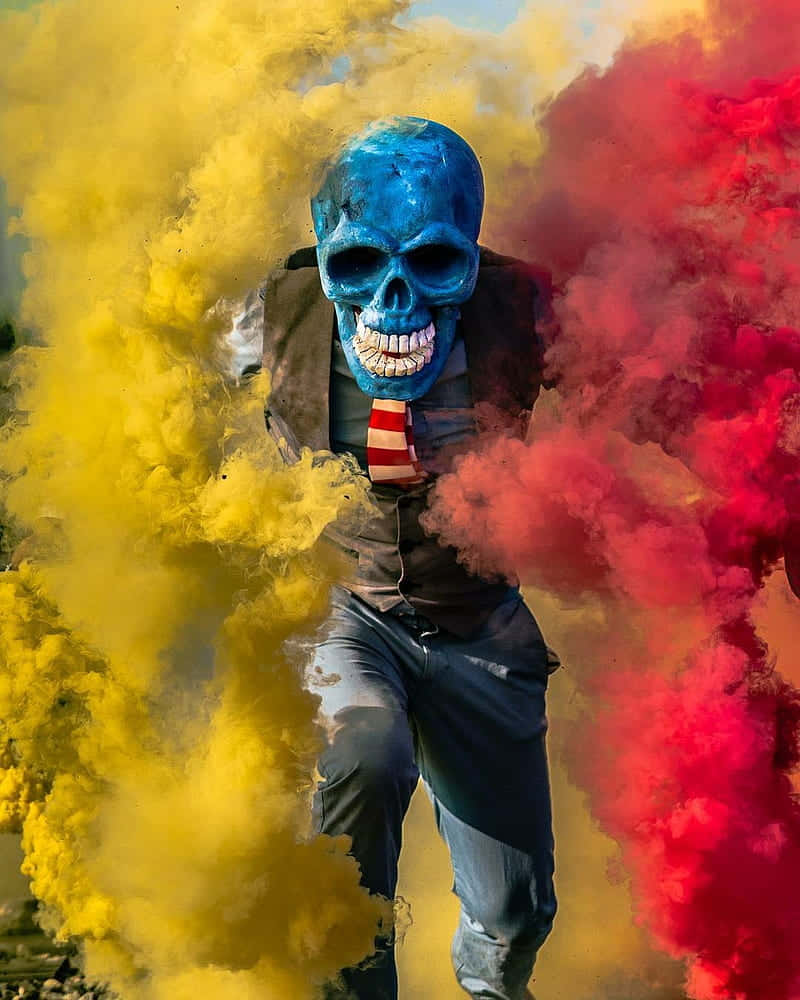A Man In A Blue And Yellow Mask Running Through Smoke Background