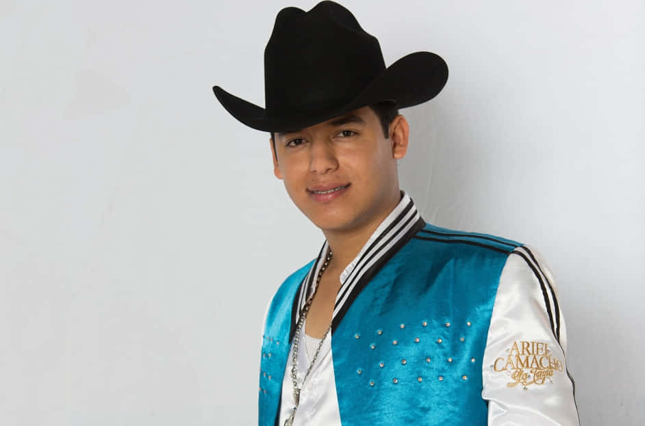 A Man In A Blue Jacket And Hat Background