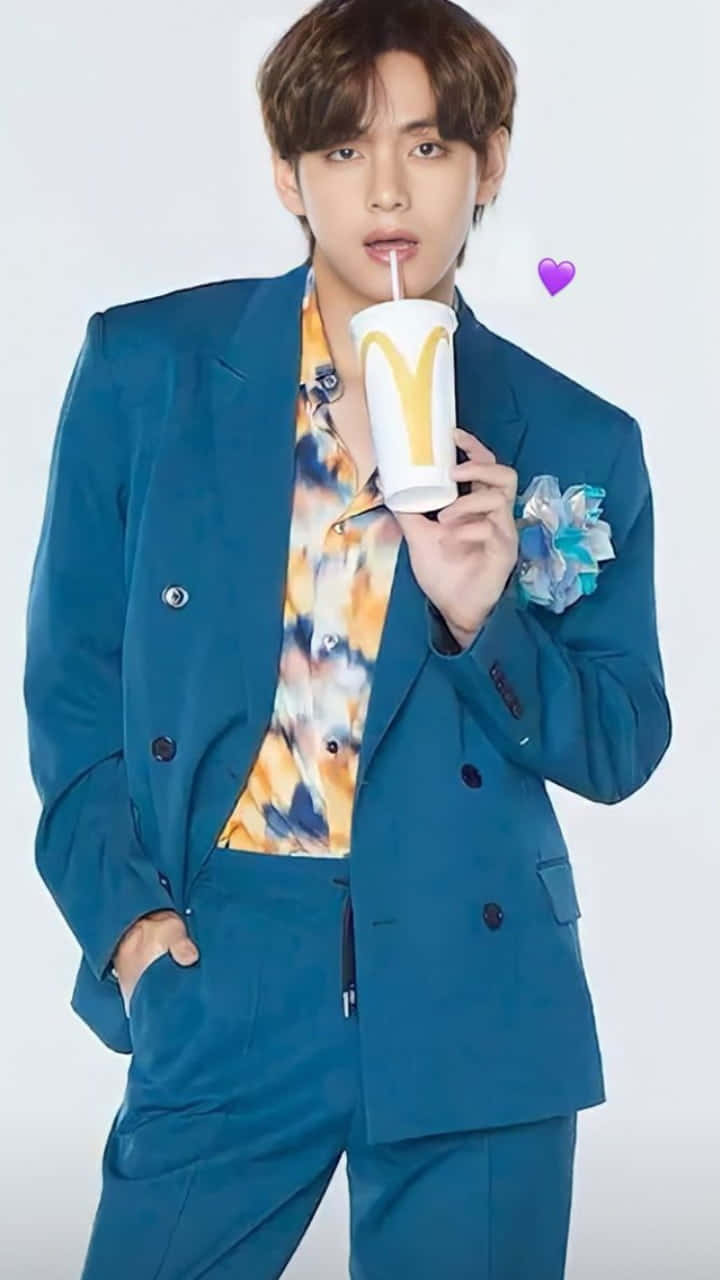 A Man In A Blue Suit Holding A Cup Of Coffee Background