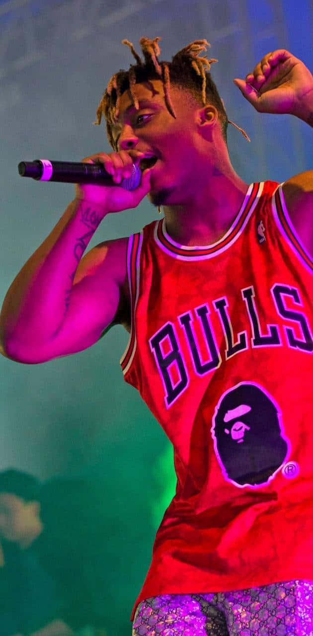 A Man In A Chicago Bulls Jersey Singing Into A Microphone