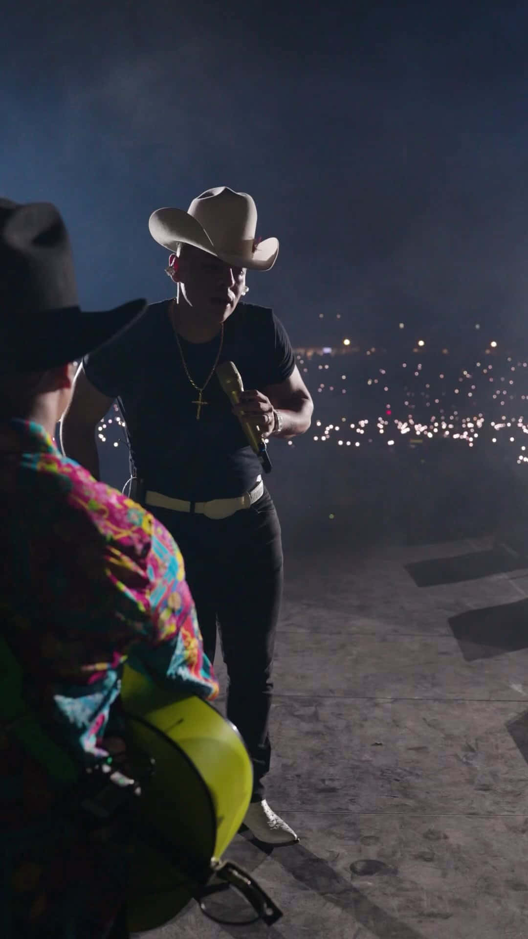 A Man In A Cowboy Hat Is Standing Next To A Man In A Cowboy Hat Background