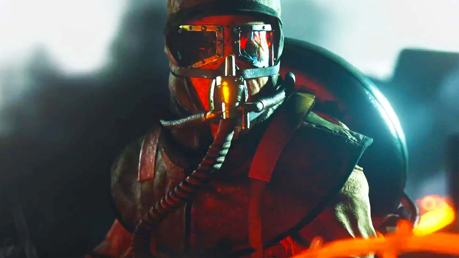 A Man In A Gas Mask Is Standing In Front Of Fire Background